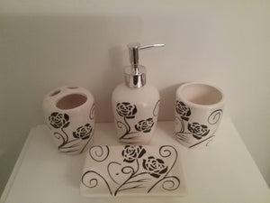Black And White Bathroom Accessory Set, which includes black flowers on the set.  The set includes a lotion dispenser, toothbrush/toothpaste holder, soap dish and rinse cup
