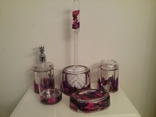 Purple and Pink Floating Flowers Bathroom Accessory Set. The set includes a toilet brush and holder, lotion dispenser, soap dish, toothbrush holder and tumbler.