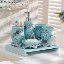 Load image into Gallery viewer, Sky Blue 5 piece resin bathroom accessory set with dark blue roses as vine on the set.  The set includes:  a lotion dispenser, soap dish, two tumblers and a toothbrush/toothpaste holder.