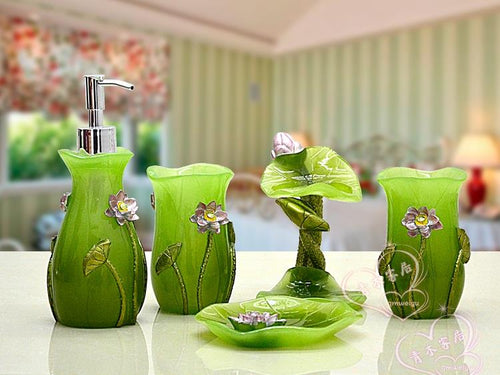 Five Piece lime green artistic design bathroom accessory set.  It includes:  lotion dispenser, soap dish, two tumblers and toothbrush holder.